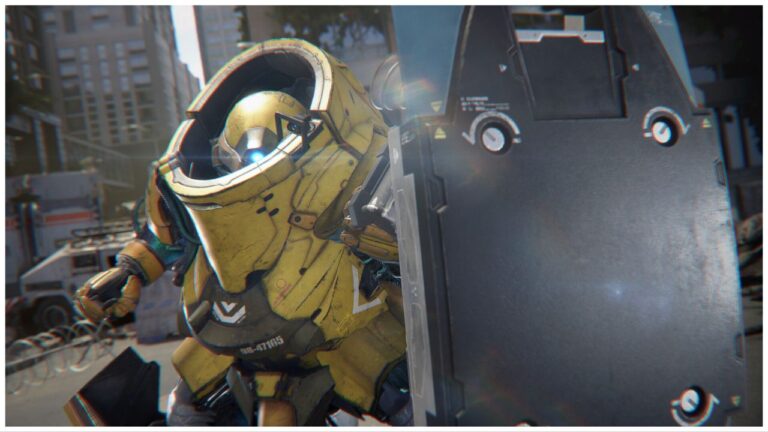 feature image for our exoprimal tier list, the image features a screenshot of a character wearing an exosuit while holding a large metal shield to block them from attacks, they seem to be in some sort of a city
