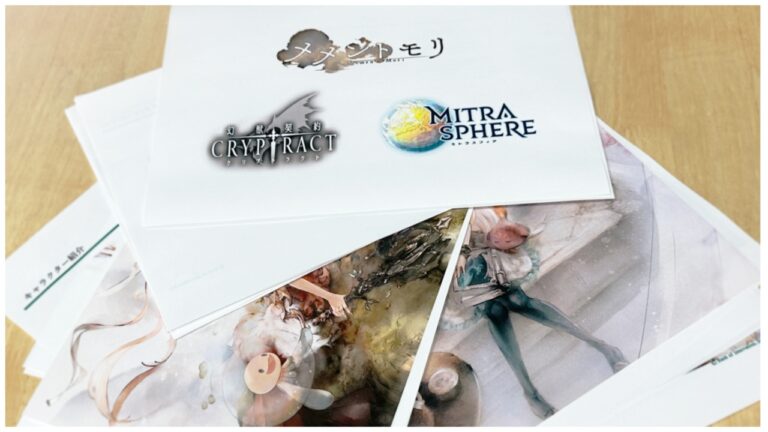 Loose printouts scattered on the table. They are logos of the three games - Memento Mori, Cryptract, and Mitrasphere