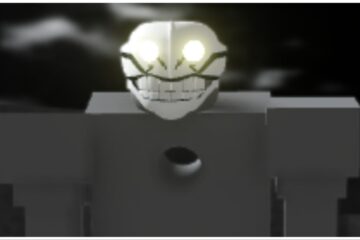 The image shows a close up of a hollow which has broad blocky grey shoulders and a white mask with unnerving glowing eyes and wide teeth
