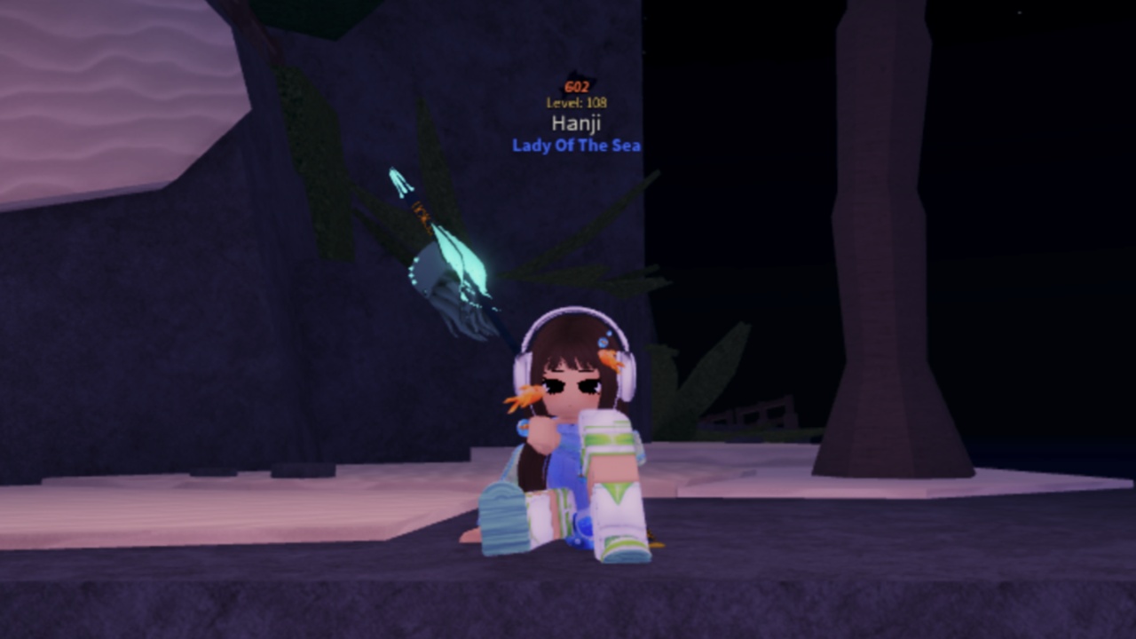 Image from the game Fisch showing a character sitting down on some rock and sand.